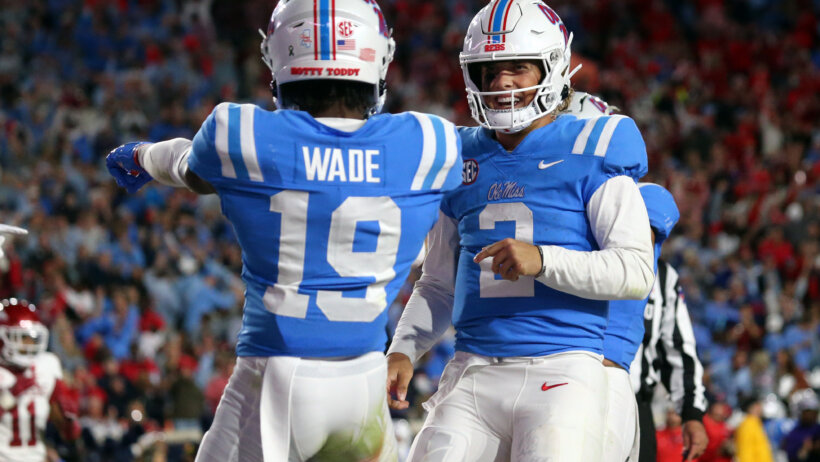 Mississippi Rebels quarterback Jaxson Dart reacts with wide receiver Dayton Wade
