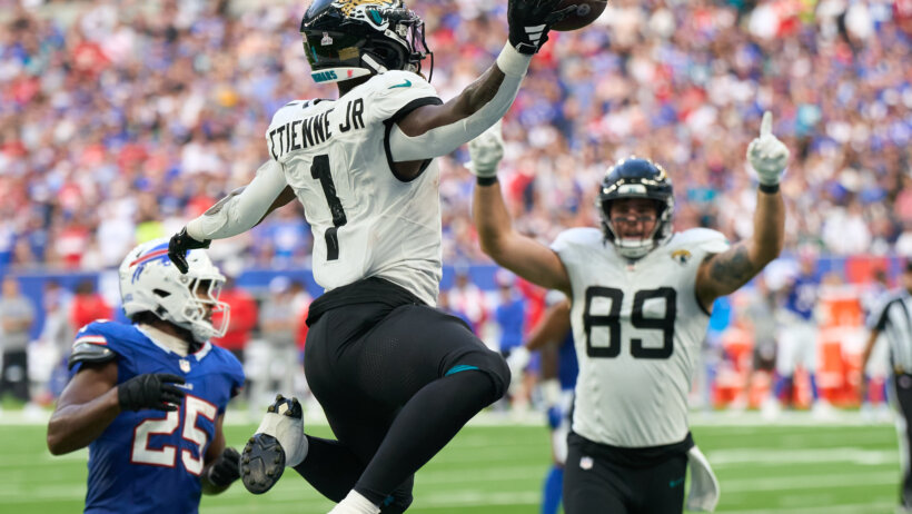 Jacksonville Jaguars running back Travis Etienne Jr. (1) jumps into the end zone for a touchdown
