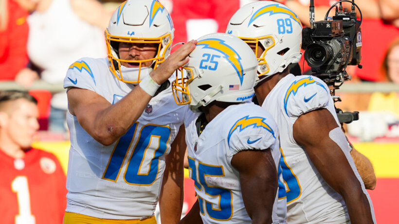 Los Angeles Chargers quarterback Justin Herbert (10) and tight end Donald Parham Jr. (89) congratulate running back Joshua Kelley (25)