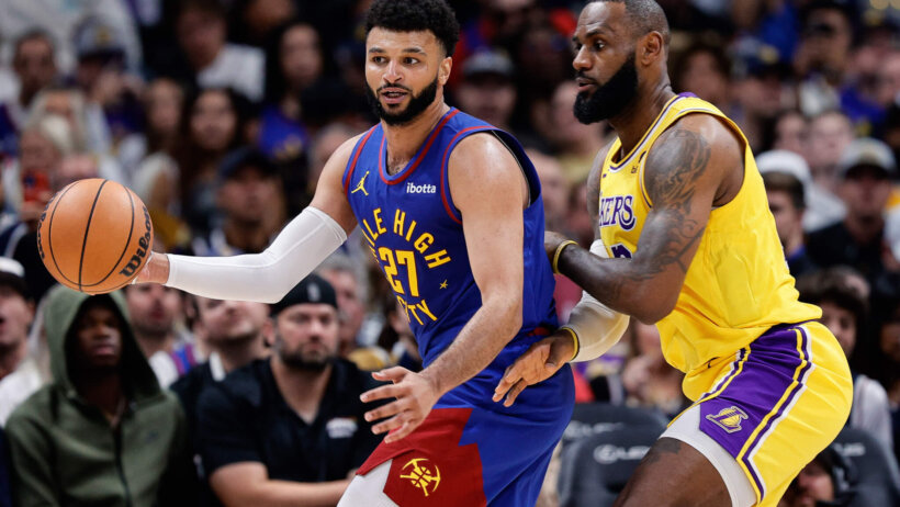 Denver Nuggets guard Jamal Murray controls the ball as Los Angeles Lakers forward LeBron James