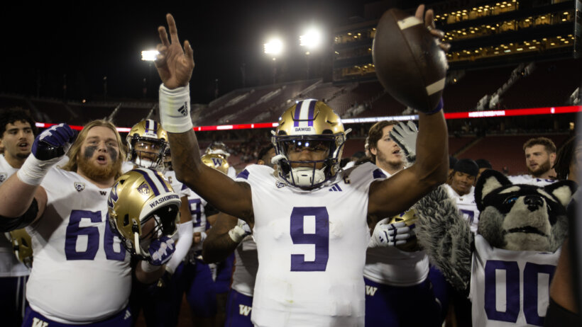 Washington Huskies quarterback Michael Penix Jr. and his teammates celebrate their victory