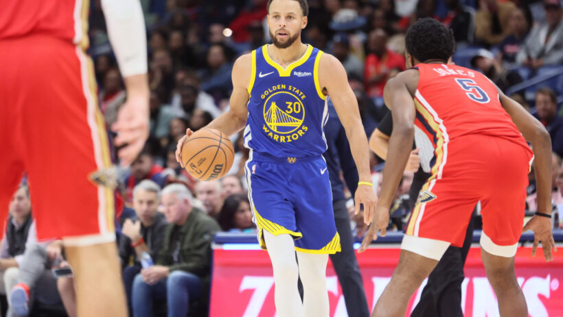 Golden State Warriors guard Stephen Curry dribbling up the court against the New Orleans Pelicans