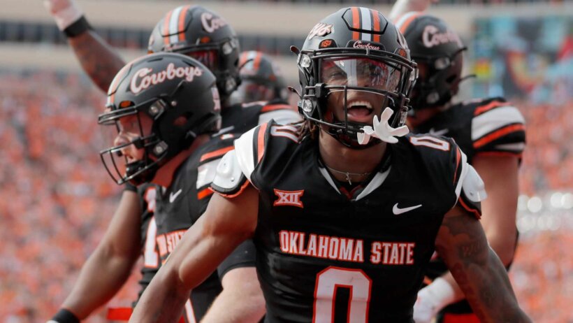 Oklahoma State's Ollie Gordon II celebrates a Alan Bowman touchdown