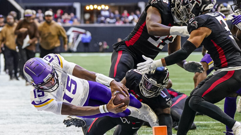 Minnesota Vikings quarterback Joshua Dobbs (15) dives trying to reach the pylon