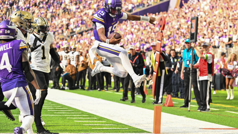 Minnesota Vikings quarterback Joshua Dobbs (15) scores on a touchdown