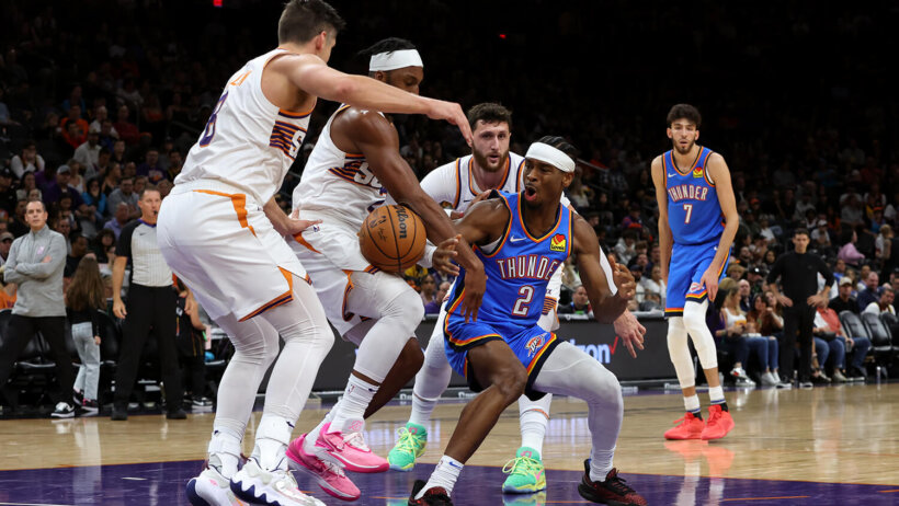 Phoenix Suns forward Keita Bates-Diop strips the ball away from Oklahoma City Thunder guard Shai Gilgeous-Alexander