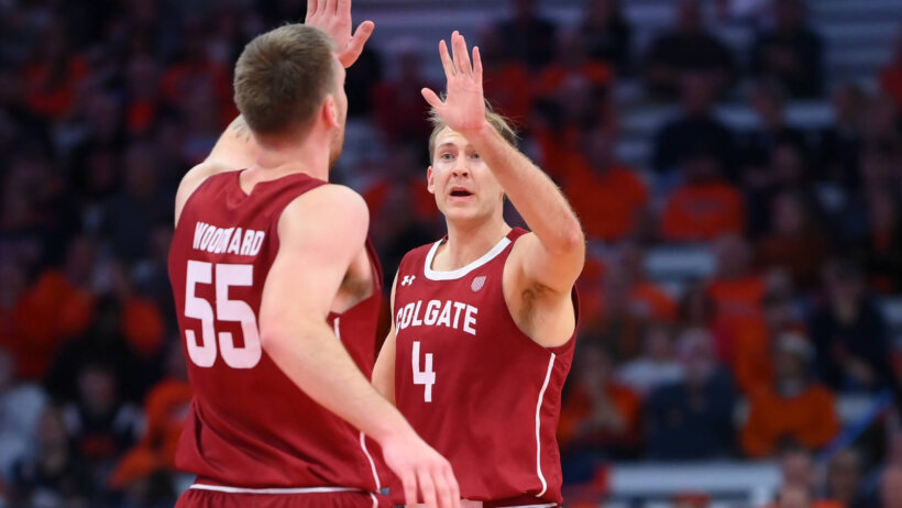 Colgate Raiders guard Braeden Smith high-fives forward Jeff Woodward