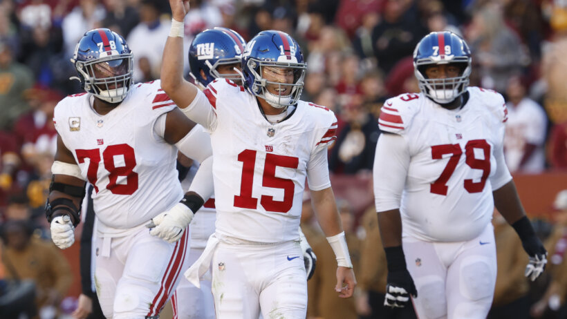 New York Giants quarterback Tommy DeVito (15) celebrates after throwing a touchdown pass