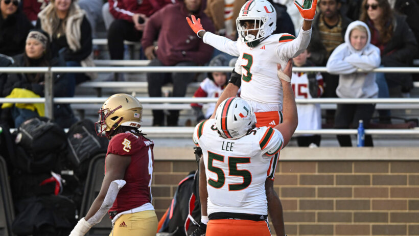 Miami Hurricanes wide receiver Jacolby George celebrates with center Matt Lee after scoring a touchdown against the Boston College Eagles