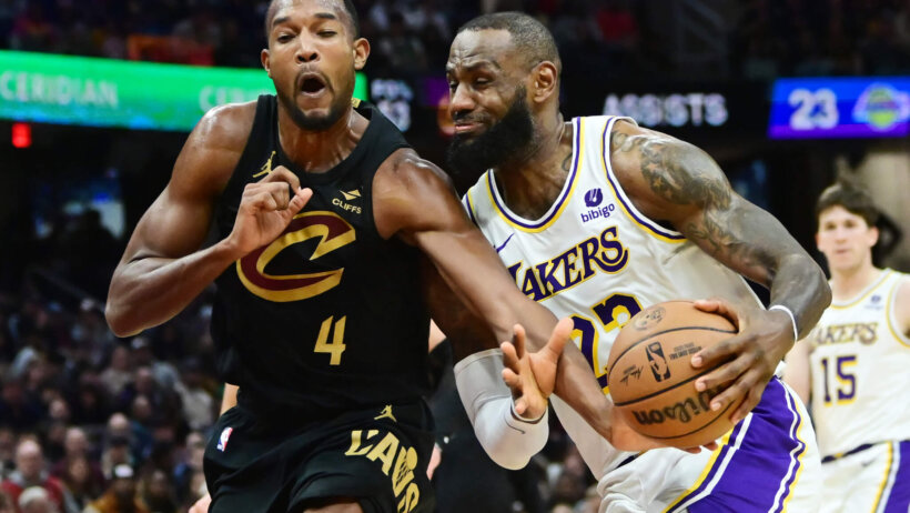 Cleveland Cavaliers forward Evan Mobley fouls Los Angeles Lakers forward LeBron James