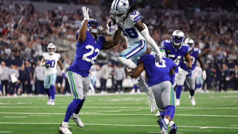 Dallas Cowboys wide receiver CeeDee Lamb (88) is tackled by Seattle Seahawks cornerback Tre Brown