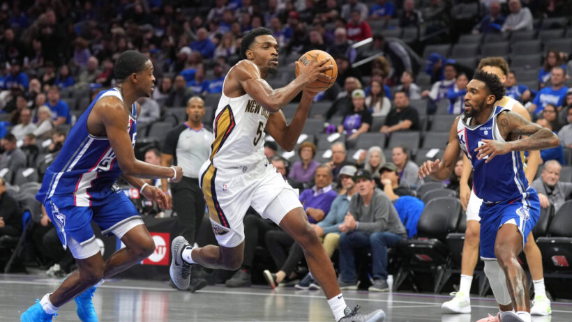 New Orleans Pelicans forward Herbert Jones drives to the basket against a pair of Sacramento Kings defenders