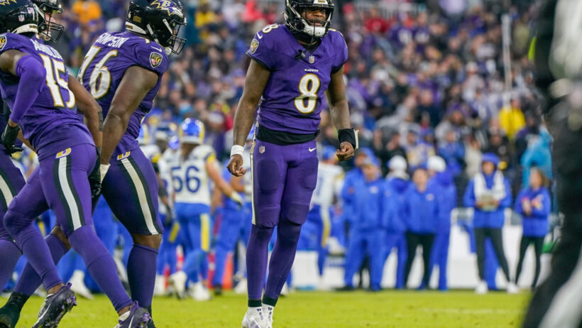 Baltimore Ravens QB Lamar Jackson jumping purple jersey