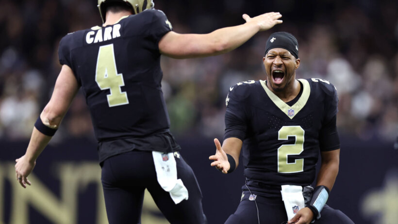 New Orleans Saints QBs Winston and Carr celebrating high five black and gold jerseys