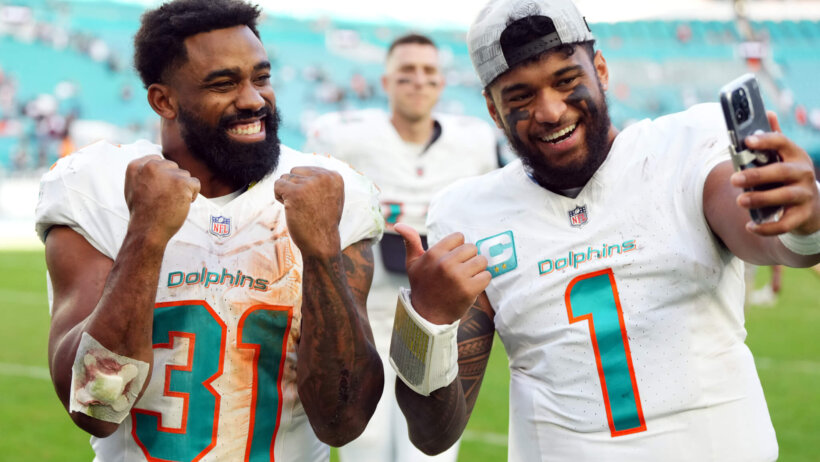 Miami Dolphins quarterback Tua Tagovailoa and running back Raheem Mostert celebrate after defeating the New York Jets at Hard Rock Stadium