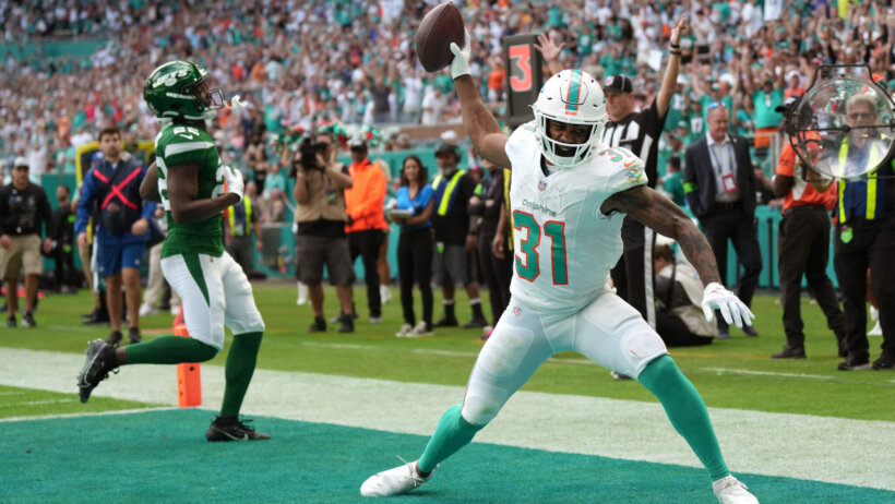 Miami Dolphins running back Raheem Mostert (31) spikes the ball after scoring a touchdown