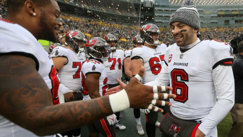 Tampa Bay Buccaneers quarterback Baker Mayfield (6) slaps hands with guard Nick Leverett