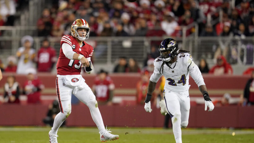 San Francisco 49ers quarterback Brock Purdy (13) throws a pass in front of Baltimore Ravens linebacker Jadeveon Clowney (24)