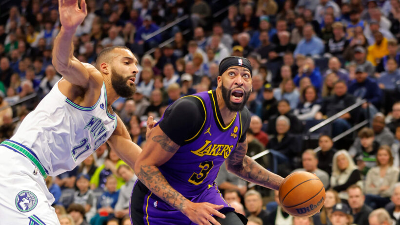 Los Angeles Lakers forward Anthony Davis dribbles around Minnesota Timberwolves center Rudy Gobert