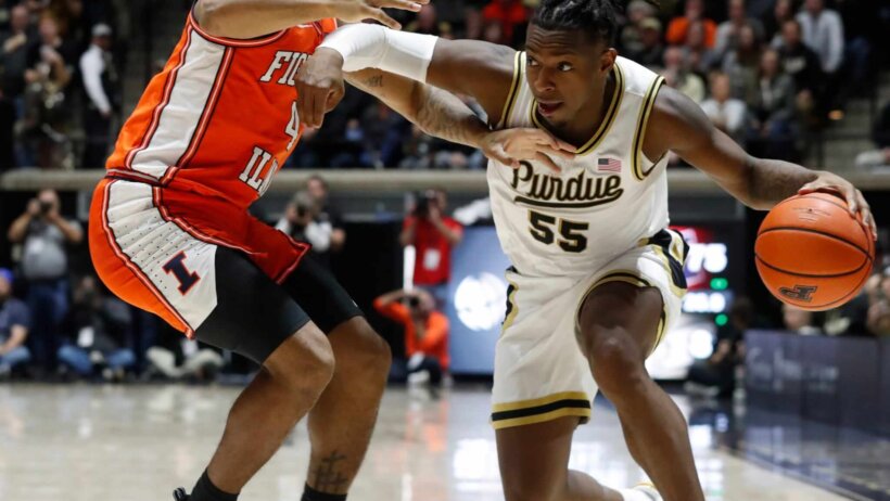 Purdue Boilermakers guard Lance Jones attempts to drive around Illinois Fighting Illini guard Justin Harmon