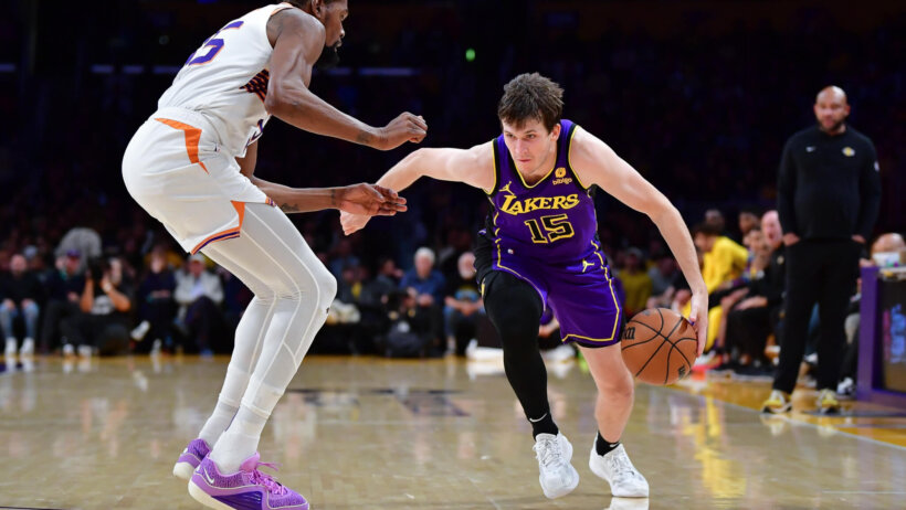 Los Angeles Lakers guard Austin Reaves drives past Phoenix Suns forward Kevin Durant