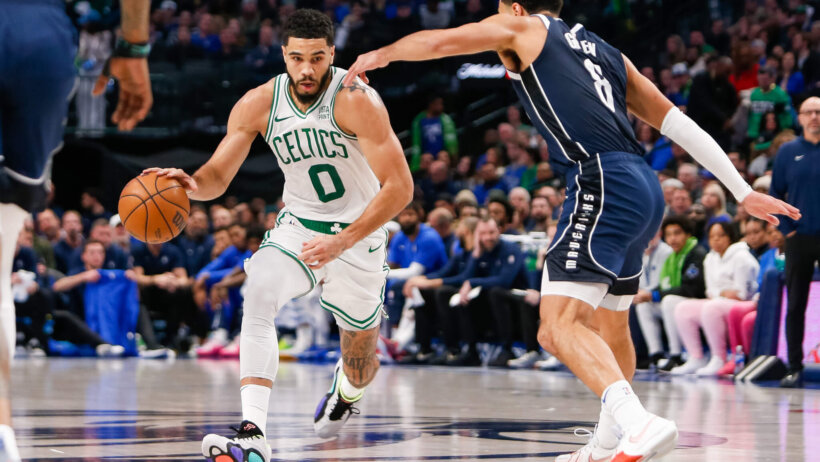 Boston Celtics forward Jayson Tatum drives at Dallas Mavericks guard Josh Green