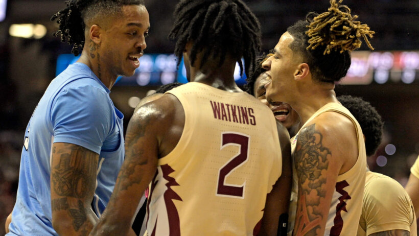 North Carolina Tar Heels center Armando Bacot and Florida State Seminoles forward De'Ante Green face to face