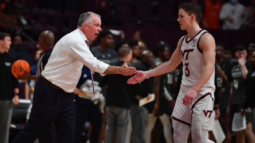 Virginia Tech Hokies head coach Mike Young high-fives Virginia Tech Hokies guard Sean P