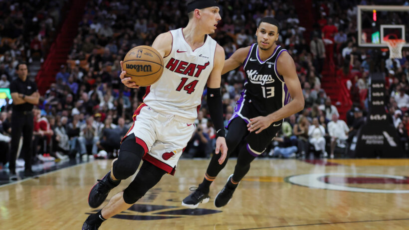 Miami Heat guard Tyler Herro drives to the hoop while Sacramento Kings forward Keegan Murray gives chase