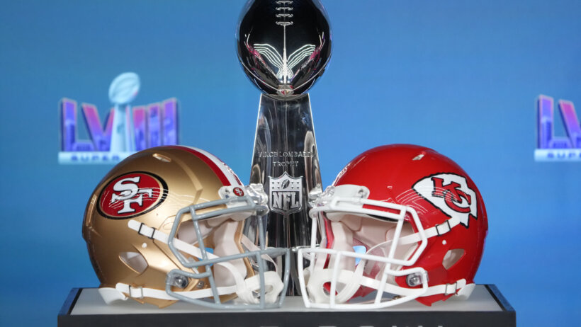 Helmets for the San Francisco 49ers and Kansas City Chiefs on a pedastal