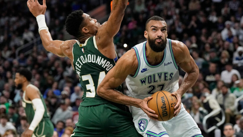 Minnesota Timberwolves center Rudy Gobert works around Milwaukee Bucks forward Giannis Antetokounmpo