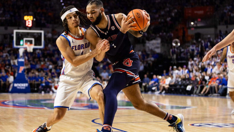 Auburn Tigers forward Johni Broome dribbles while Florida Gators guard Walter Clayton Jr defends