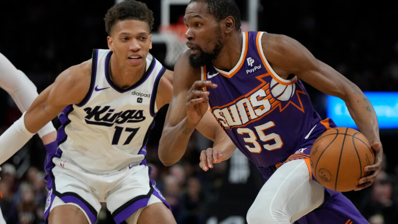 Phoenix Suns forward Kevin Durant drives on Sacramento Kings forward Kessler Edwards