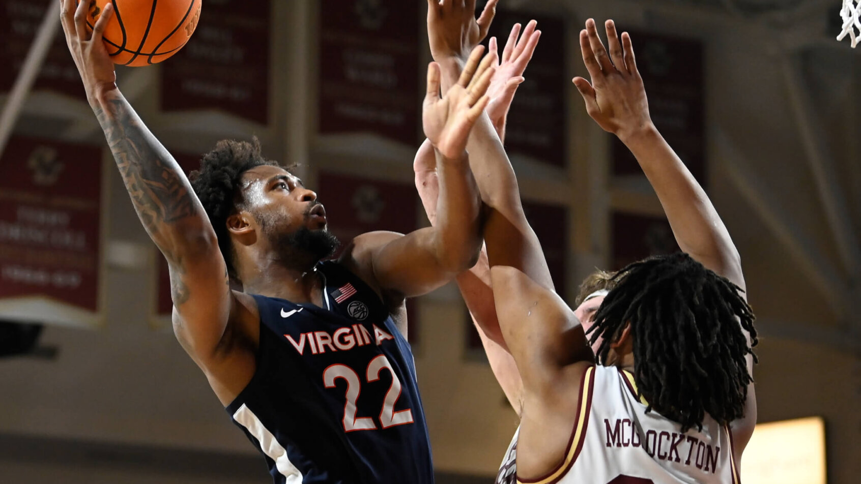 Virginia Cavaliers forward Jordan Minor shoots over two Boston College Eagles defenders