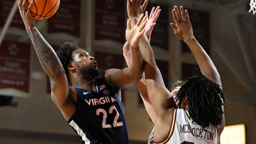 Virginia Cavaliers forward Jordan Minor shoots over two Boston College Eagles defenders