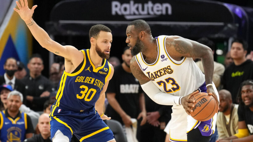 Los Angeles Lakers forward LeBron James handles the ball against Golden State Warriors guard Stephen Curry