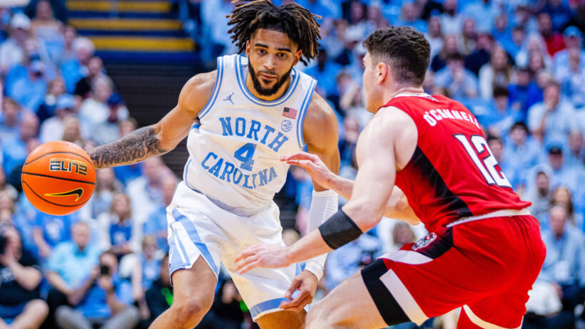 North Carolina Tar Heels guard RJ Davis is guarded by North Carolina State Wolfpack guard Michael O'Connell