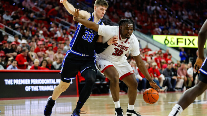 North Carolina State Wolfpack forward DJ Burns Jr tries to dribble past Duke Blue Devils center Kyle Filipowski