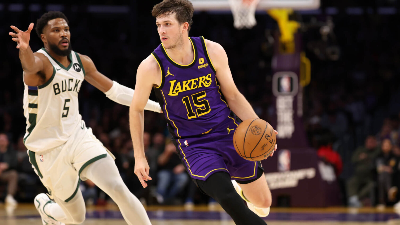 Los Angeles Lakers guard Austin Reaves drives to the basket against Milwaukee Bucks guard Malik Beasley