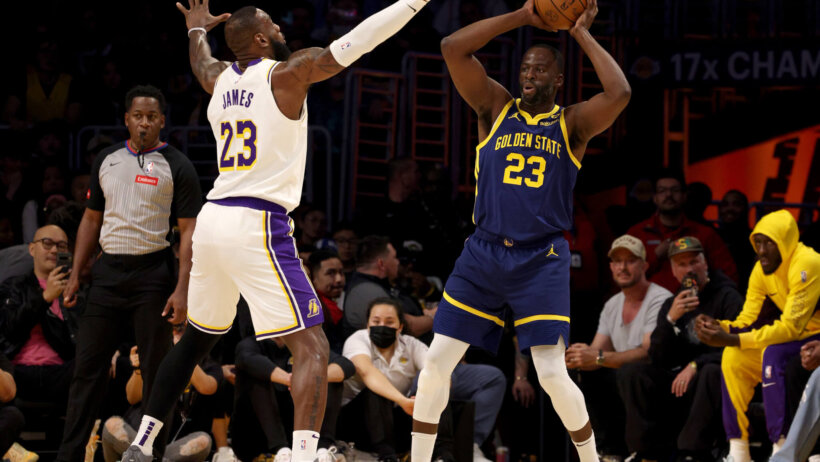 Golden State Warriors forward Draymond Green looks to pass as Los Angeles Lakers forward LeBron James defends