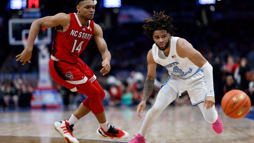 North Carolina State Wolfpack guard Casey Morsell and North Carolina Tar Heels guard RJ Davis going after a loose ball