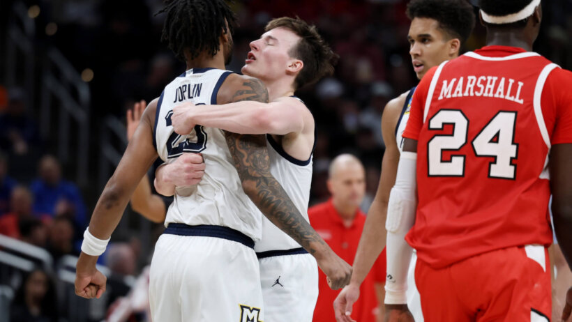 Marquette Golden Eagles forward David Joplin and guard Tyler Kolek hugging