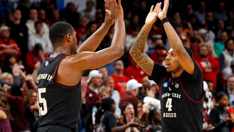 Texas A&M Aggies forward Henry Coleman III and Wade Taylor IV high-fiving