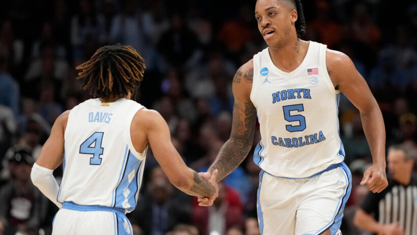 North Carolina Tar Heels forward Armando Bacot low-fives guard RJ Davis