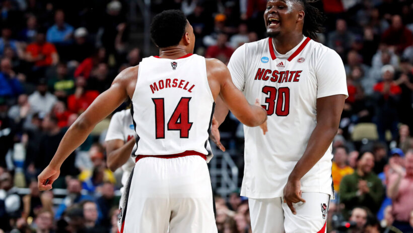 North Carolina State Wolfpack guard Casey Morsell celebrates with forward DJ Burns
