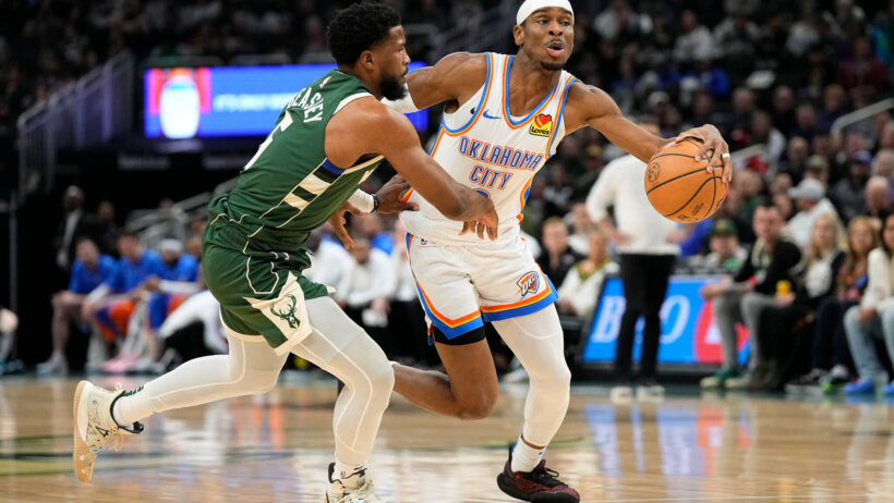 Oklahoma City Thunder guard Shai Gilgeous-Alexander drives for the basket around Milwaukee Bucks guard Malik Beasley