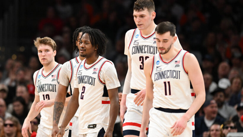 Connecticut Huskies players walking off the court