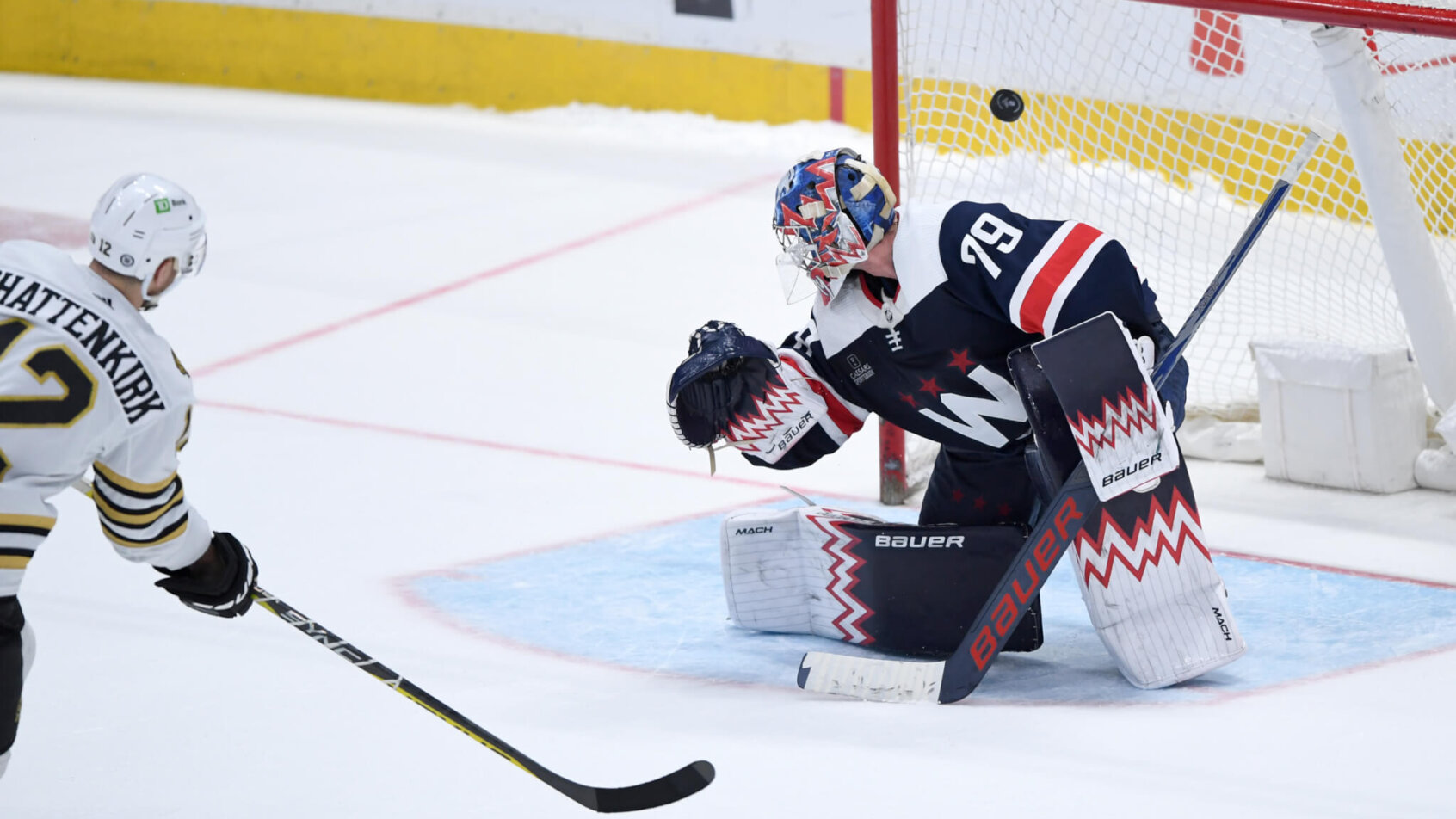 Boston Bruins defenseman Kevin Shattenkirk scores on Washington Capitals goaltender Charlie Lindgren