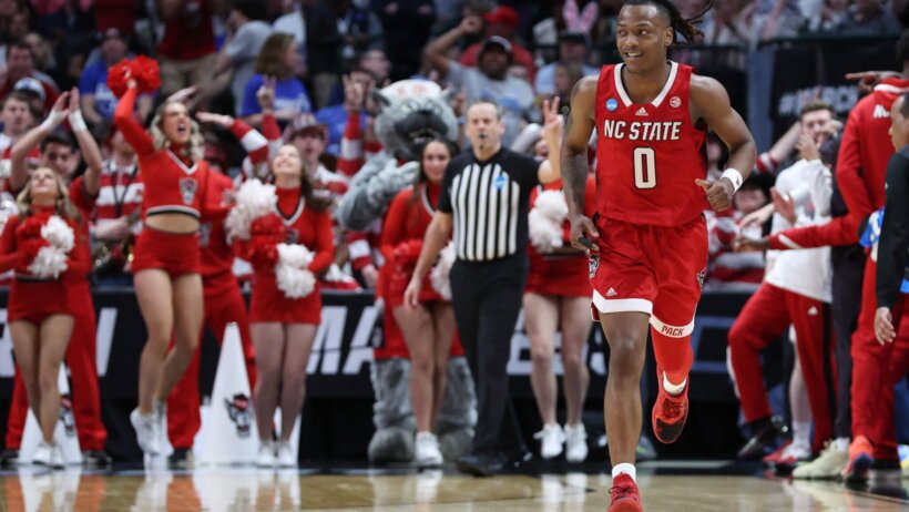 North Carolina State Wolfpack guard DJ Horne running on a basketball court.