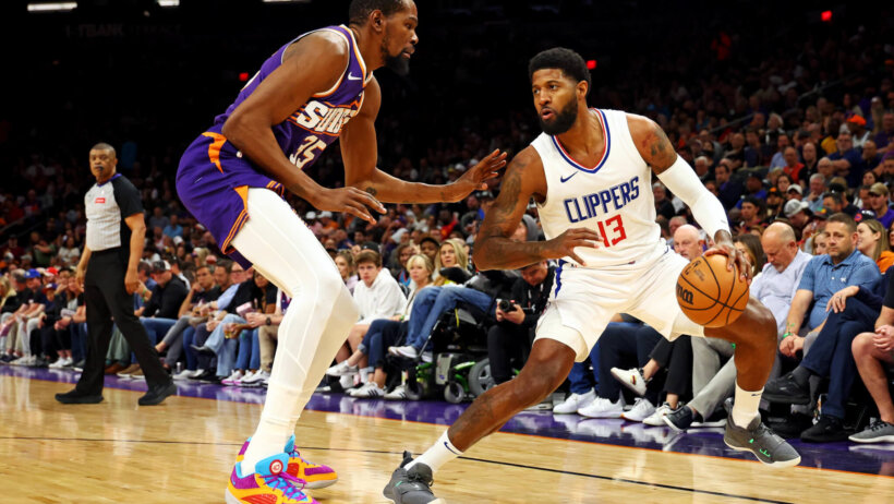 LA Clippers forward Paul George handles the ball against Phoenix Suns forward Kevin Durant